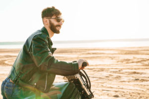 Handsome young bearded man wearing leather jacket